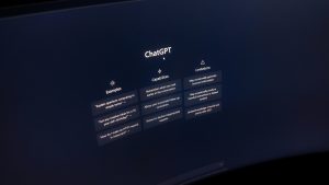 Close-up of a computer screen displaying ChatGPT interface in a dark setting.
