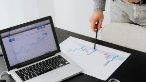 Person analyzing cryptocurrency data using a laptop, highlighting financial insights.