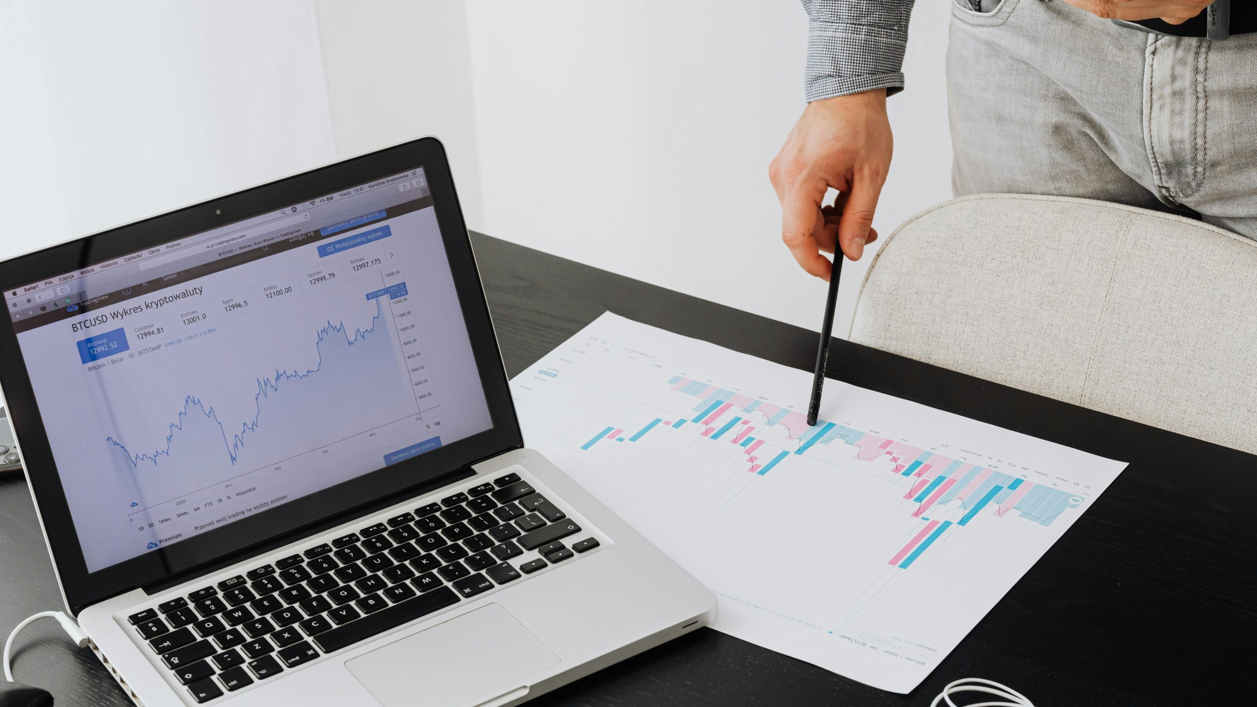 Person analyzing cryptocurrency data using a laptop, highlighting financial insights.