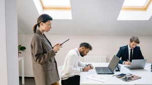 A diverse group of professionals working together in a bright, modern office space.